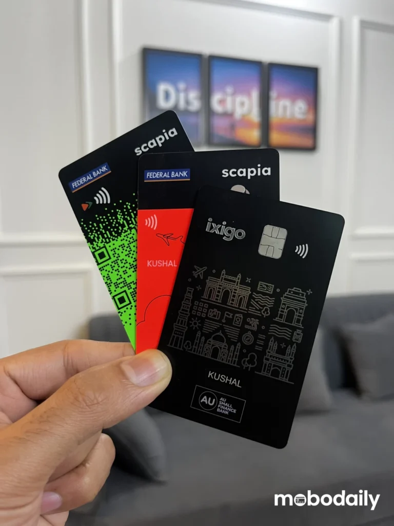 Scapia Federal Bank Visa, RuPay, and AU Ixigo credit cards held in hand